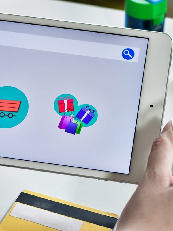 Closeup shot of a female holding a tablet with online shopping icons shopping on a drop shipping store